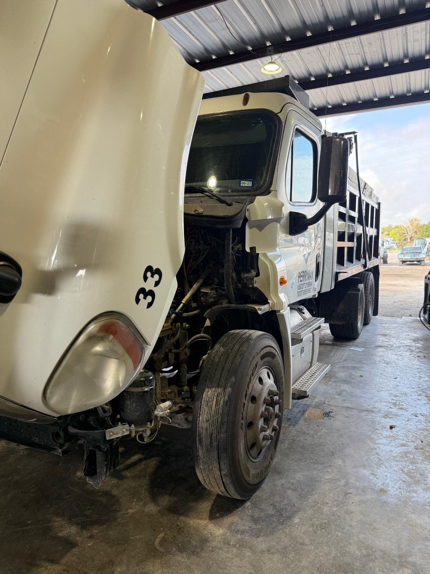Semi truck with the hood tilted open for engine diagnostics at Quality Mechanics